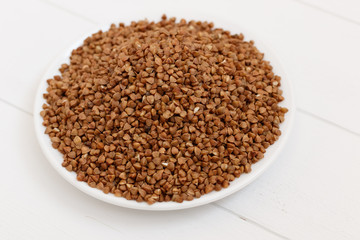 plate of buckwheat isolated on white background. Top view.