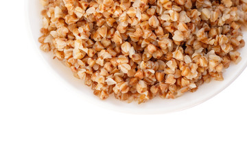 plate of buckwheat on white wood background. Top view.