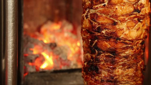 appetizing donner kebab cutting chef with tall knife, the most popular food in Turkey