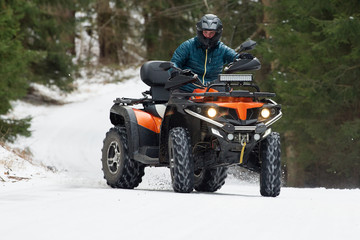 Man driving a quad bike in the winter