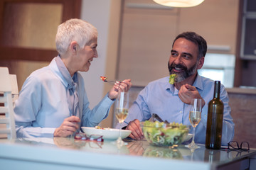 Senior people having lunch at home