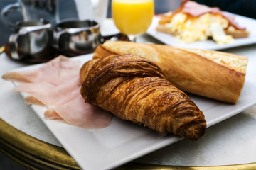 Breakfast with coffee and croissants on table