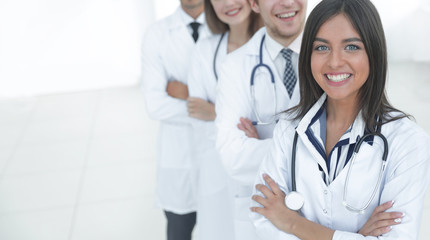 Fototapeta premium female doctor with group of happy successful colleagues