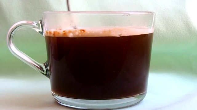 Stirring coffee in a mug.  Hot refreshing drink for Breakfast. 