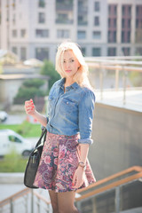Young beautiful caucasian blonde girl in the city