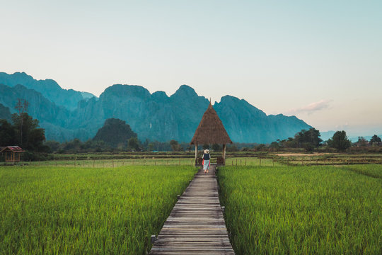 Woman standing at straw arbor