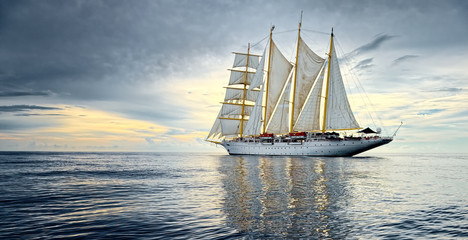 Fototapeta na wymiar Sailing ship against the background of beautiful sky and ocean. Yachting. Sailing