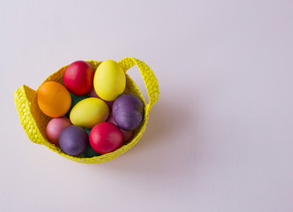 on the table basket with painted eggs - easter background