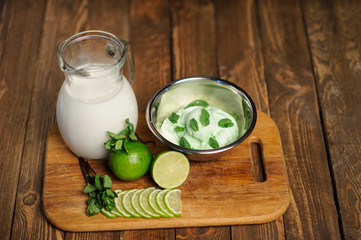 Fresh lemon and lime homemade ice cream in a white cup of milk
