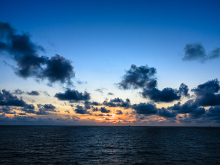 Blue sea and blue sky with white cloud and sunrise up from sea in gulf of Thailand.