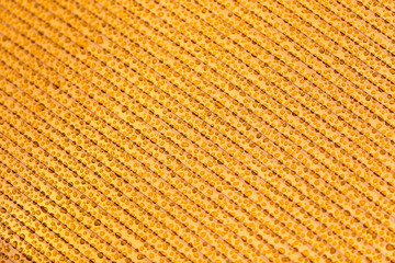 Drops of water on orange plastic as background