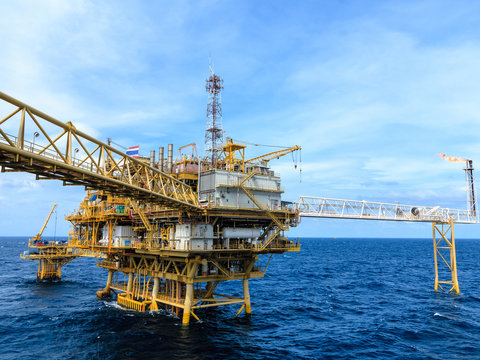 Offshore oil and Gas central processing platform and remote platform produced oil, natural gas and liquid condensate for set to onshore refinery from offshore in ocean sea background.