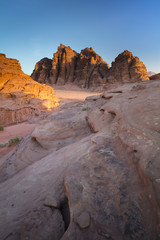 three rocks in sunset lights in desert in Jordan
