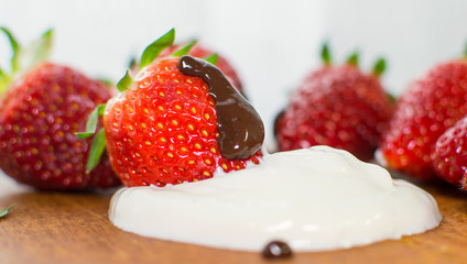 Strawberry with chocolate as dessert.