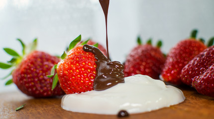 Strawberry with chocolate as dessert.