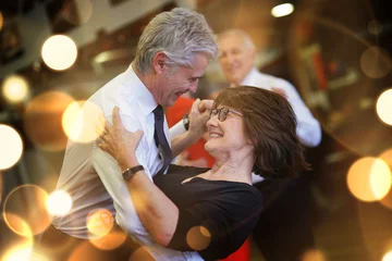 Deurstickers Romantic senior couple dancing together at dance hall © goodluz