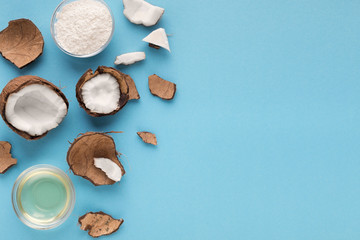 Obraz na płótnie Canvas Plate with coconut flour and water on blue background
