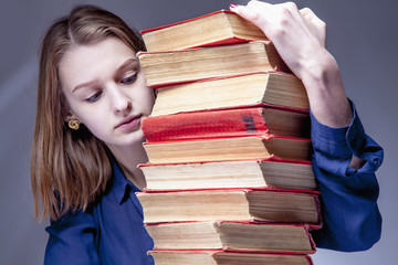 Knowledge pays best investment for future. Young Student Girl with Books  (Education and self...