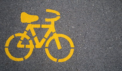 Top - view,Yellow bike symbol on the street in Urban city. transportation concept.