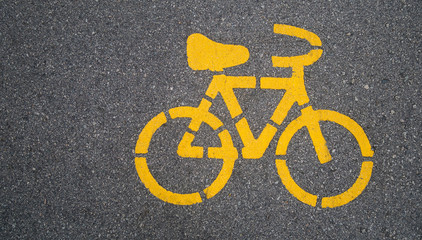 Naklejka premium Top - view,Yellow bike symbol on the street in Urban city. transportation concept.