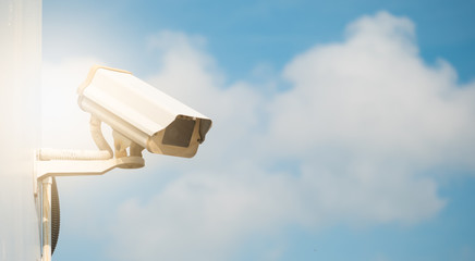 CCTV camera in security system in urban city with sky background in security concept,Soft focus with sun light.