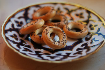 Sushki-traditional russian small bread rings with poppy seeds on top on a plate.