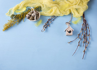 Easter background: painted eggs, birdhouse, branch of mimosa and willow