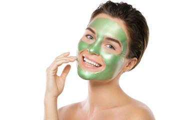 Woman with green peel-off mask on her face