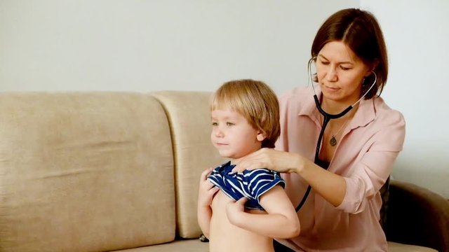 Mother checking a baby with stetoscope