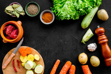 Diet vegetarian vegan food. Ratatouille or vegetable ragout. Black table background top view space...