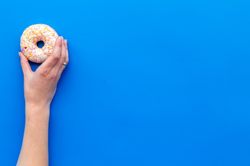 glazed donut for dessert on blue background flat lay mock up