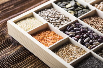 Healthy food and diet theme. Lentils, peas, beans, protein food in bowls, on a wooden table. 