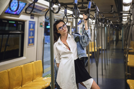 Sexy model is posing in carriage of metro train