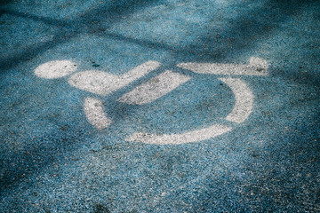 Obraz premium Disabled parking sign drawing on the ground.