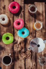 Colorful donuts on wooden table. Top view