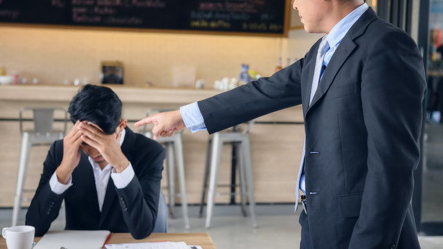 Angry boss  complain young businessman