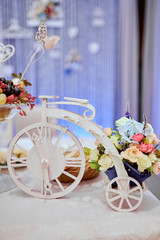 Wedding decor, flowers, rings, bouquet in the hands, rings, groom and bride