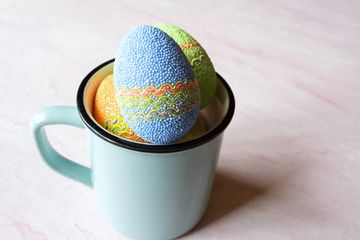 Easter egg in a cup. Beautiful easter background. Homemade holiday decor.	