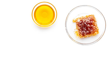 Honeycomb filled with honey on plate on white background top view space for text