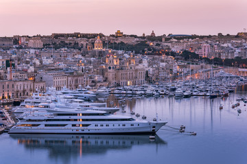 Birgu at evening and luxury yachts in harbor,Malta