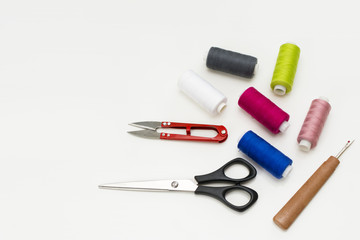 Tailor's work desk. Pattern of sewing accessories and tools on white background top view copyspace