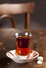Turkish tea and sugar cubes on the wooden table.