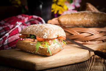 Triangular sandwich with cheese, ham and tomato.