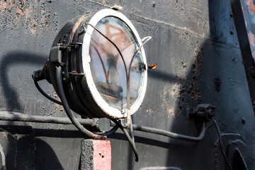 Vintage headlight of old train close