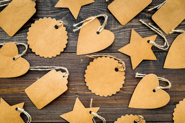 Figured blank tags for write price or discount on dark wooden background mockup pattern