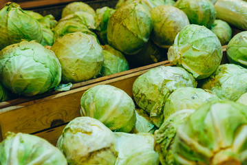 green cabbages close up. vegetables in box in grocery store