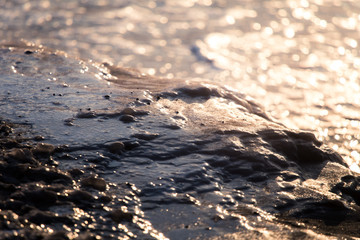 A beautiful closeup of a frozen sea water on the coast of Baltic sea. Frozen salt water vawes on a beach. Abstract closup of ice.