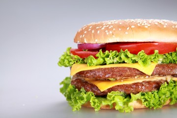 Fresh appetizing Cheeseburger with vegetables