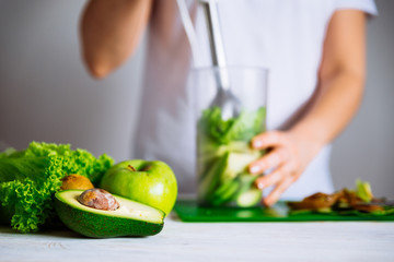 smoothie ingredients in front. woman making smoothie on background. health food concept