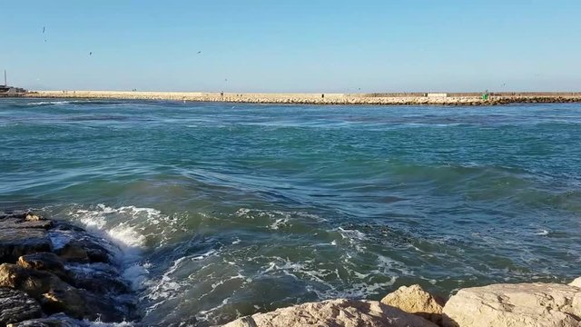 Waves crashing on seawall rocks in Denia, a Mediterranean Sea port in the Alicante province, on Costa Blanca, Spain. 